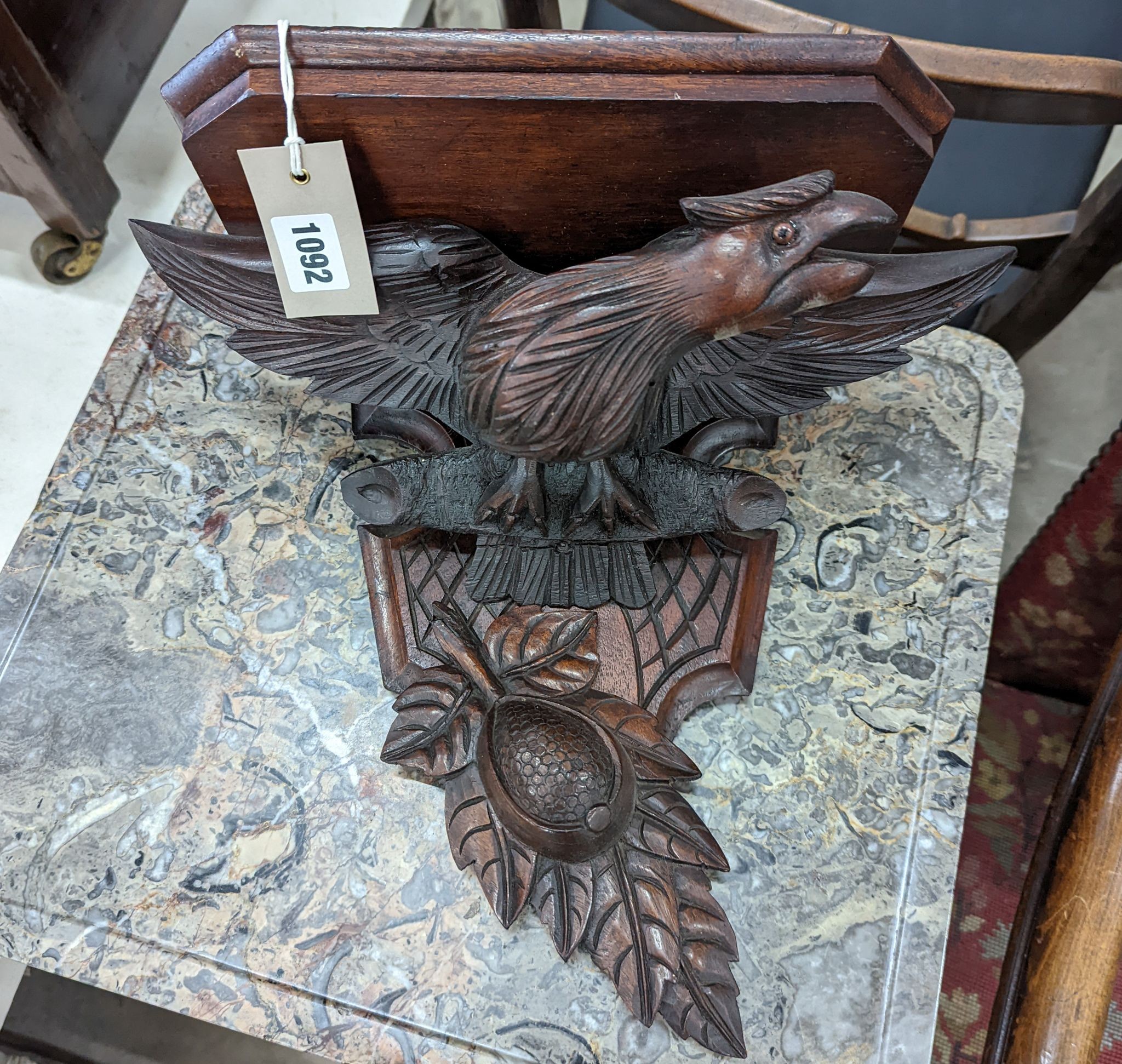 A Black Forest carved eagle wall bracket, width 34cm, height 30cm